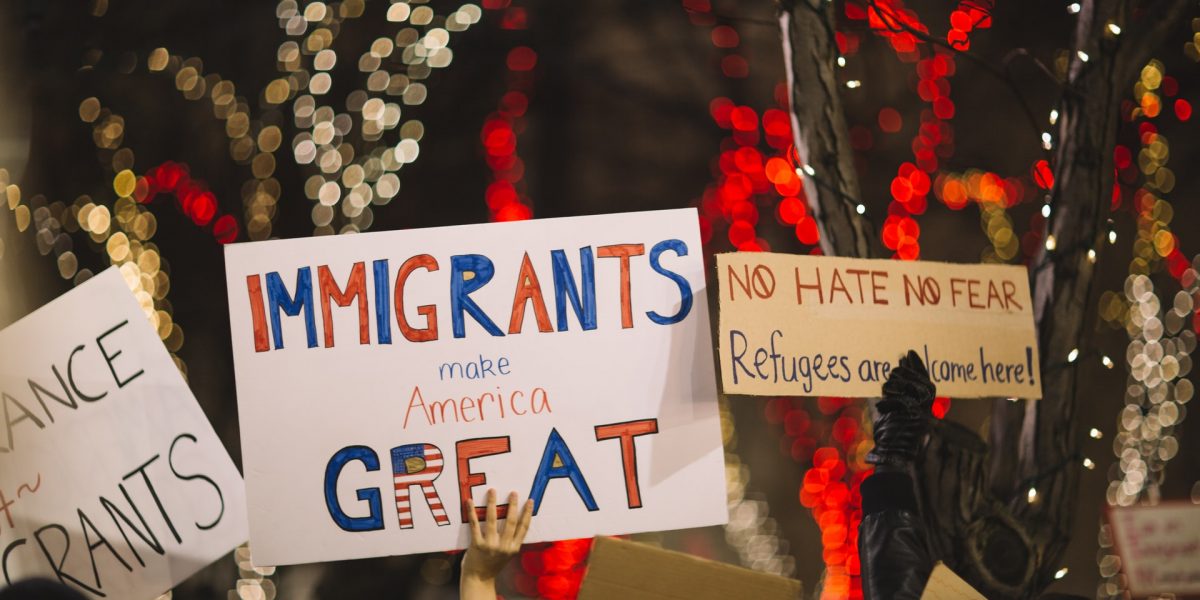 People holding signs at a protest or rally that say "immigrants are great" - Bipartisan Agreement Proved Elusive in 2017 Immigration Negotiations