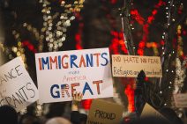 People holding signs at a protest or rally that say "immigrants are great" - Bipartisan Agreement Proved Elusive in 2017 Immigration Negotiations