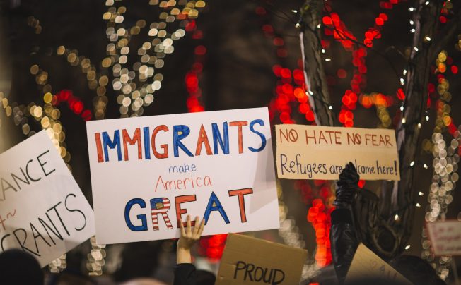 People holding signs at a protest or rally that say "immigrants are great" - Bipartisan Agreement Proved Elusive in 2017 Immigration Negotiations